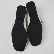 Black shoe soles on a light gray background