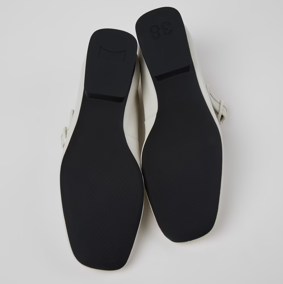 Black shoe soles on a light gray background