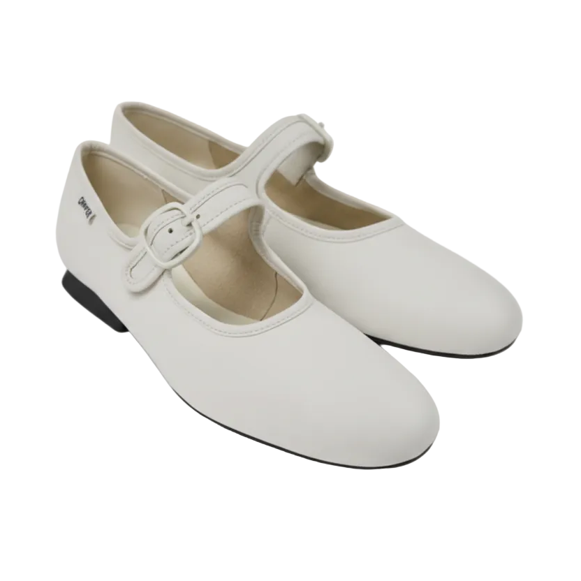 White shoes with a buckle on a light gray background