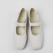 Pair of white shoes with a strap on a light gray background