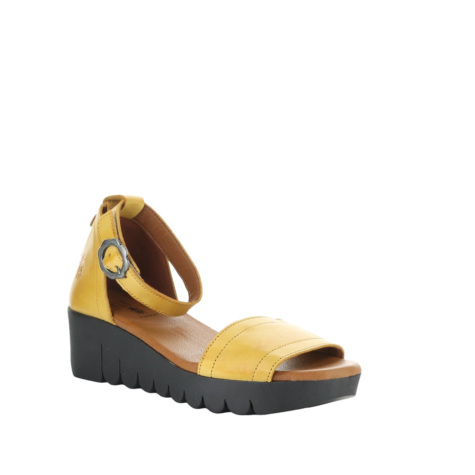 Yellow sandal with a black sole on a white background
