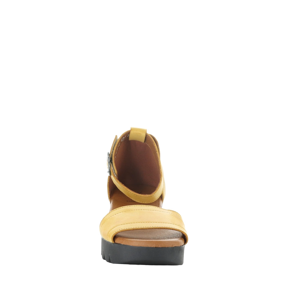 Yellow sandal with a platform sole on a white background