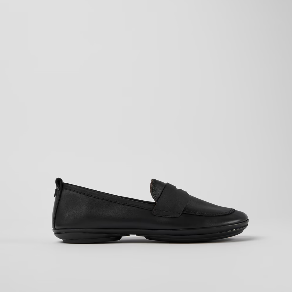 Black loafer shoe on a light gray background