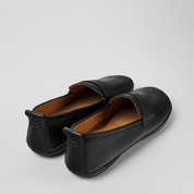 Pair of black loafers on a light gray background