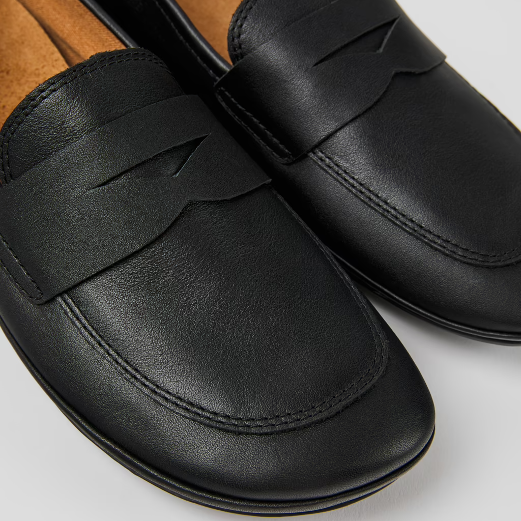 Black loafers on a light gray background
