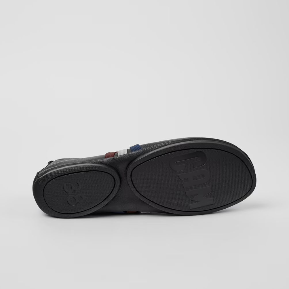 Black sandal with a thick sole on a light gray background