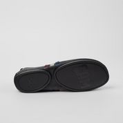 Black sandal with a thick sole on a light gray background