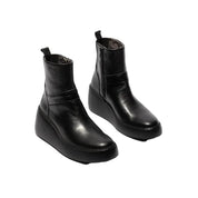 Pair of black leather ankle boots on a white background