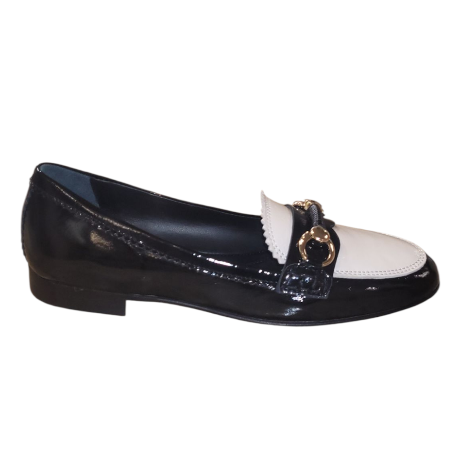 Black and white patent leather loafer with a gold buckle on a white background