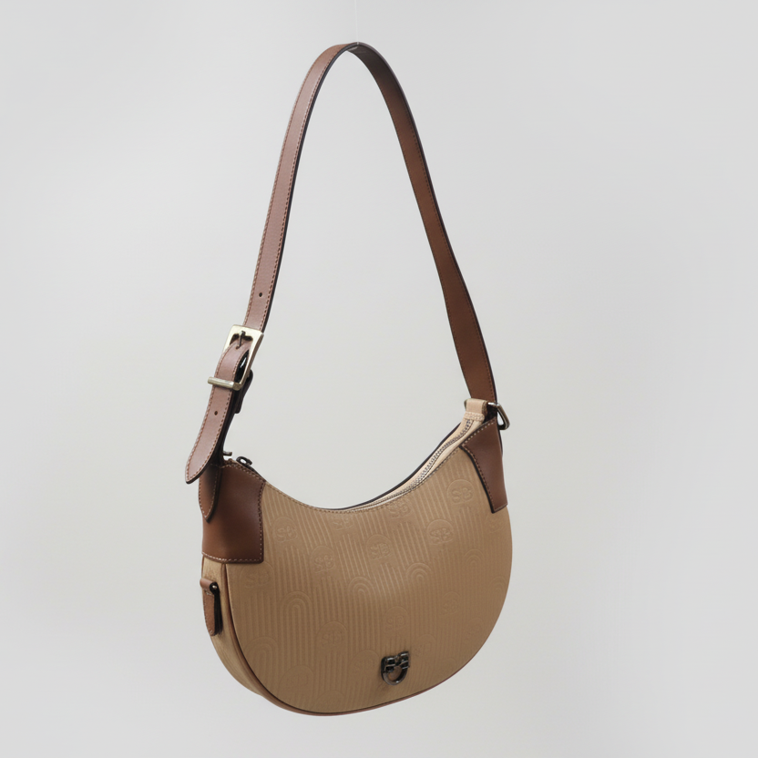 Beige handbag with a brown strap held by a hand on a white background