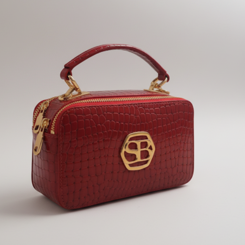 Red handbag with a gold logo on a white background