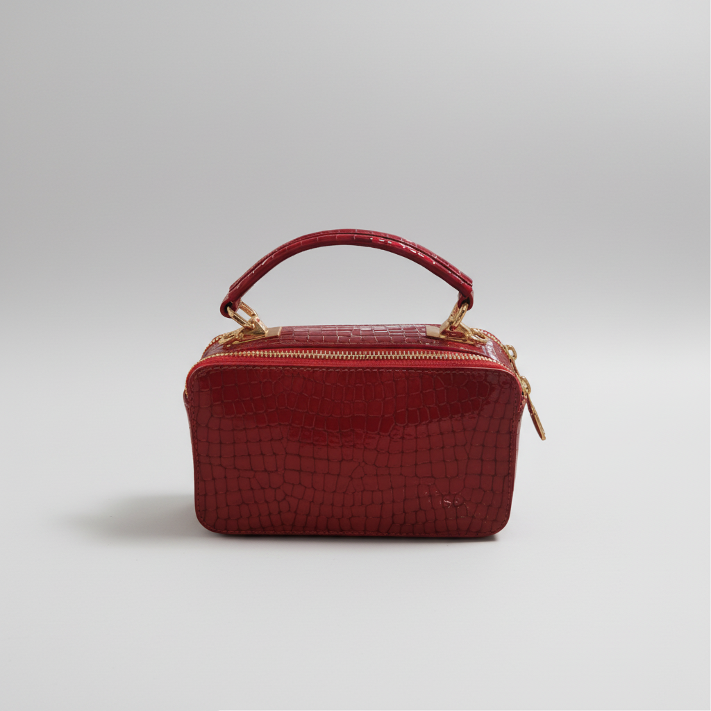 Red handbag with gold accents on a white background