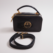 Blue handbag with gold accents on a white background