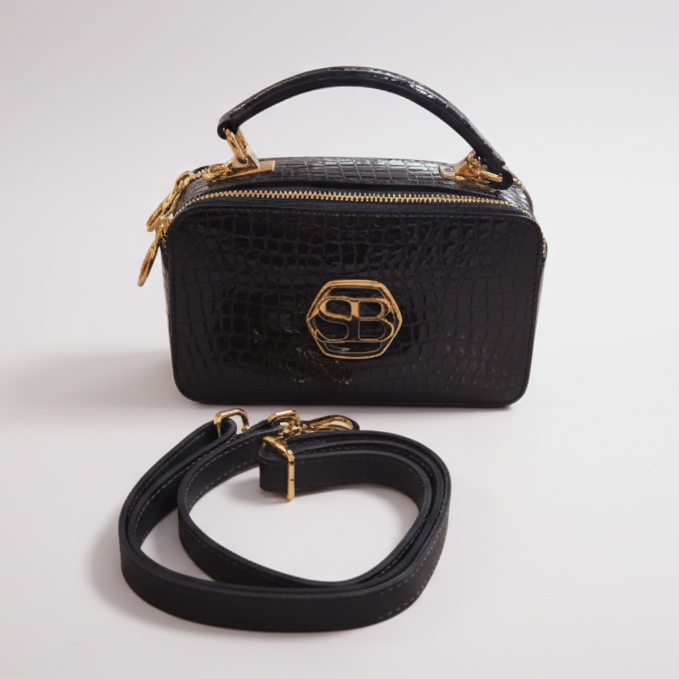 Blue handbag with gold accents on a white background