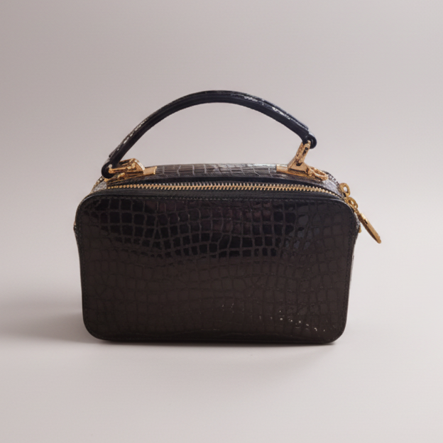 Blue handbag with gold accents on a white background