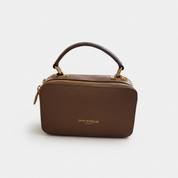 Taupe handbag with a visible brand name on a white background
