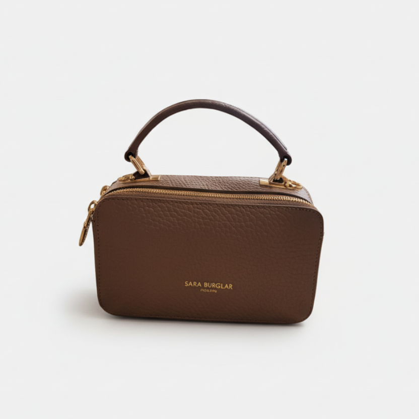 Taupe handbag with a visible brand name on a white background