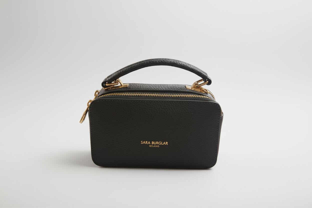 Green handbag with gold zipper on a white background