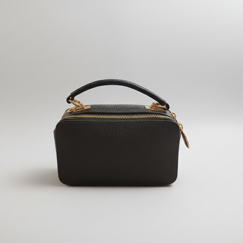 Green handbag with gold accents on a white background