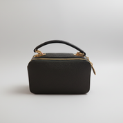 Green handbag with gold accents on a white background