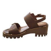 Beige sandal with thick sole on a white background