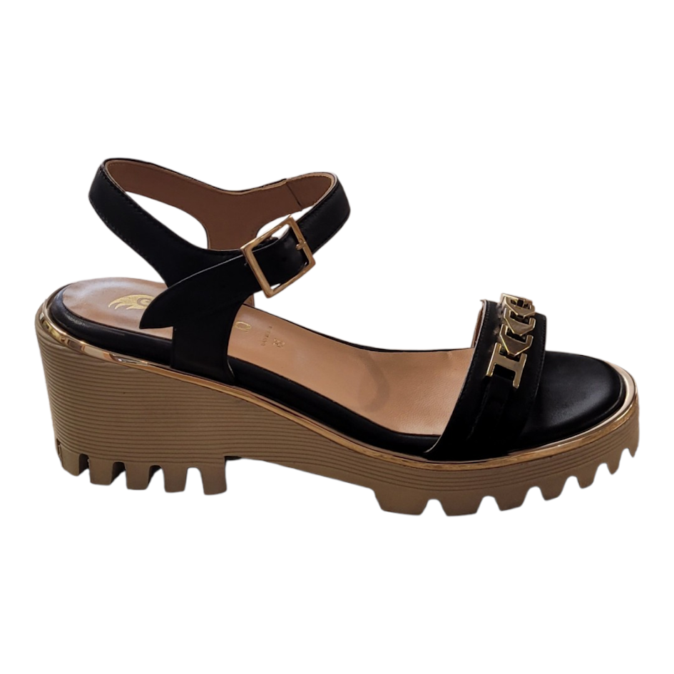 Black wedge sandal with brown sole on a white background