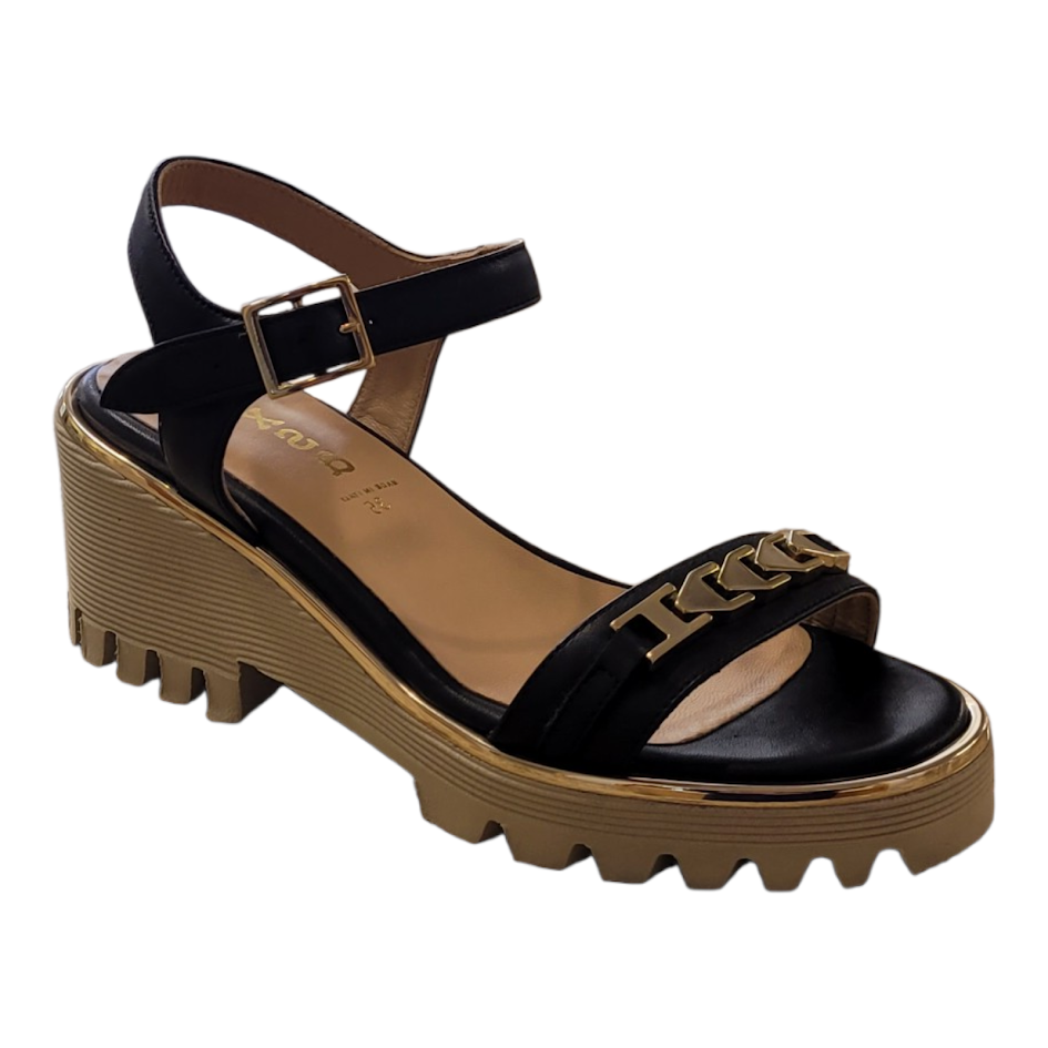Black sandal with brown sole on a white background