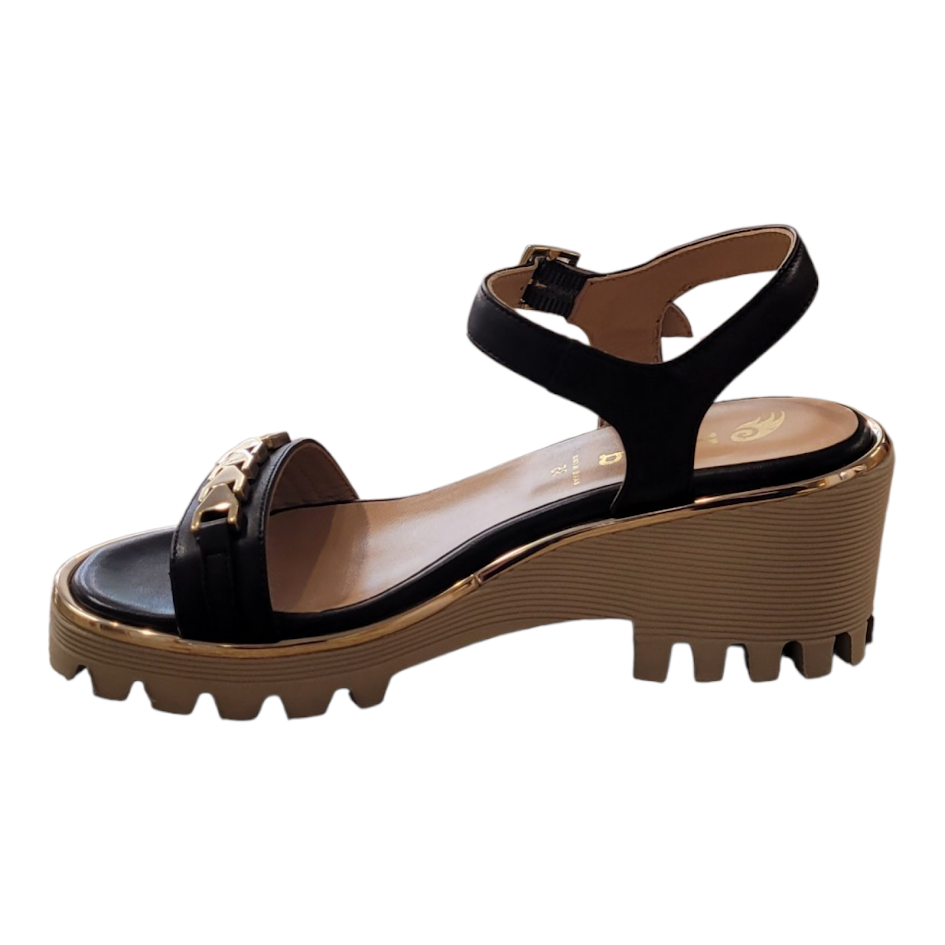 Black sandal with brown sole on a white background