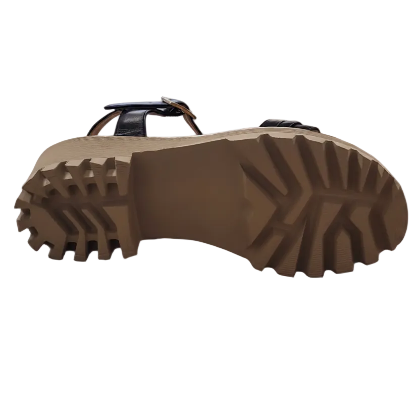 Close-up of a brown sandal sole with tread pattern on a white background