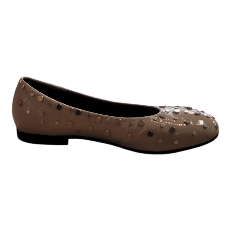 Beige flat shoe with decorative studs on a white background