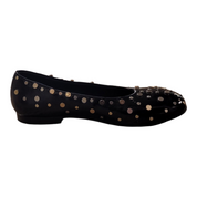 Black flat shoe with gold polka dots on a white background