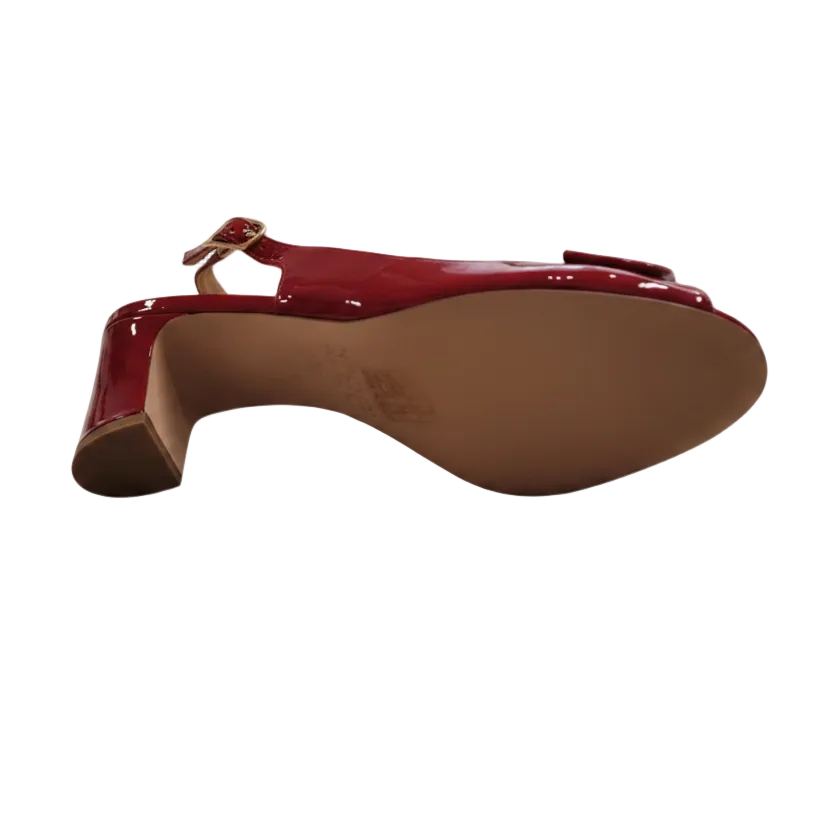 Red patent leather sandal heel on a white background