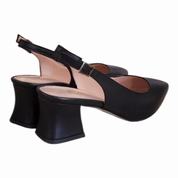 A pair of black leather slingback block-heel shoes with a low block heel, pointed toe, and a small buckle detail on the ankle strap, shown against a plain white background.