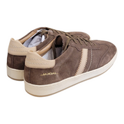 A pair of Jackal brand low-top sneakers in brown suede with beige side stripes and heel tabs, featuring a cream-colored midsole and a gold 'JACKAL' logo on the side.