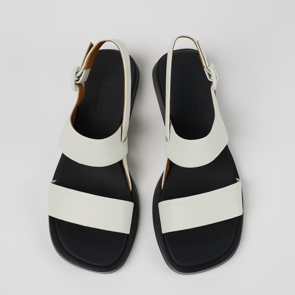 Black and white sandals on a light gray background