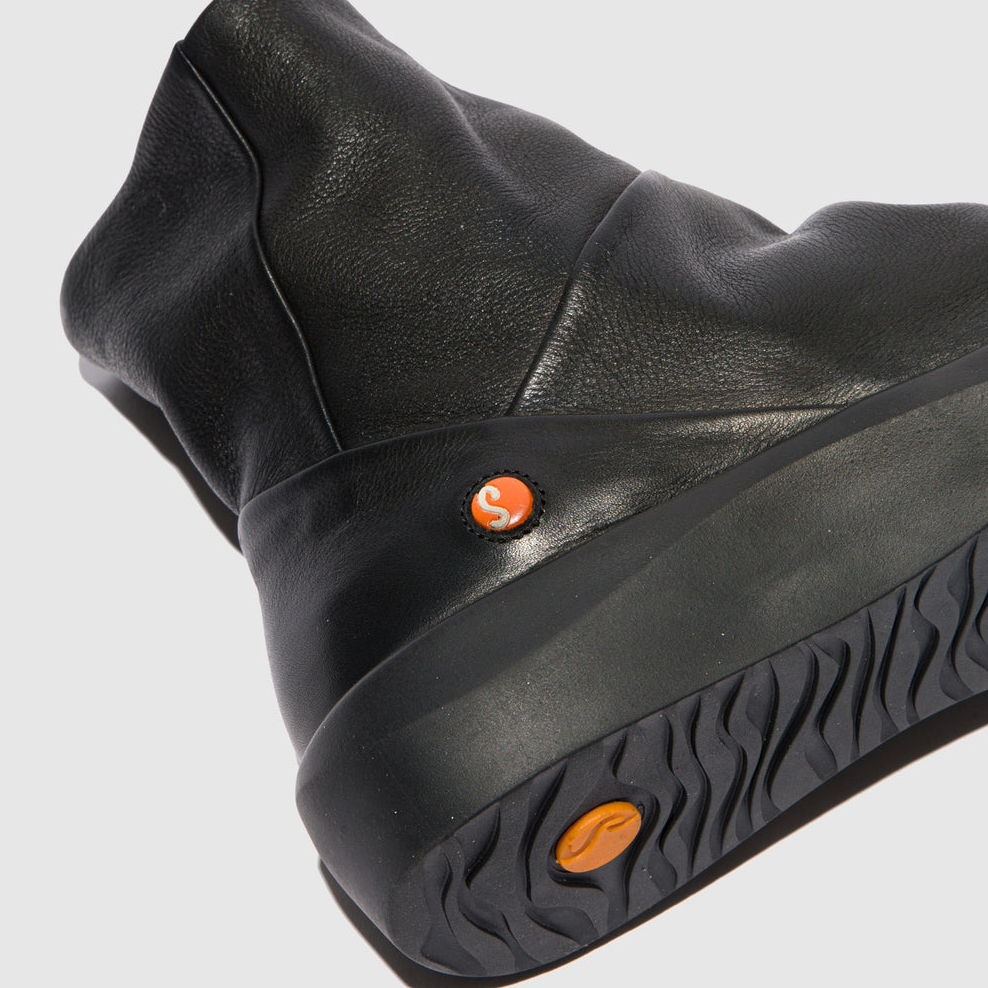 Black boot with orange accents on a light gray background