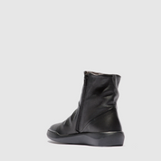 Black leather boot on a light gray background