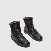 Pair of black leather boots on a light gray background