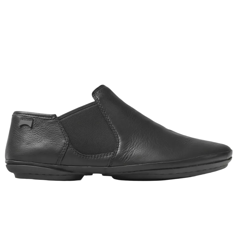 Black slip-on shoe on a white background