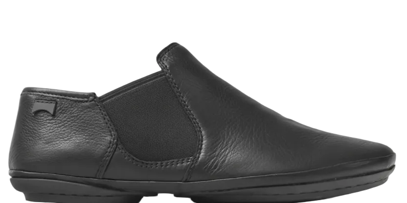 Black slip-on shoe on a white background
