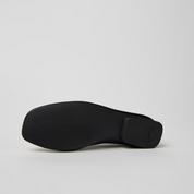 Black shoe sole on a light gray background