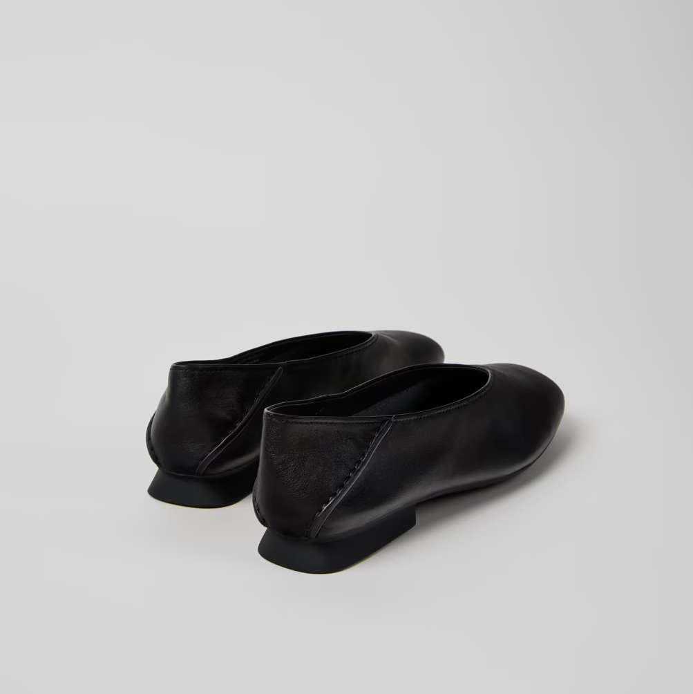 Pair of black shoes on a light gray background