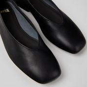 Pair of black shoes on a light gray background