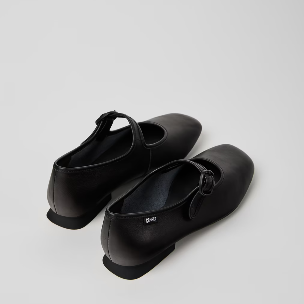 Pair of black shoes on a light gray background