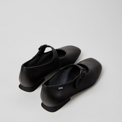 Pair of black shoes on a light gray background