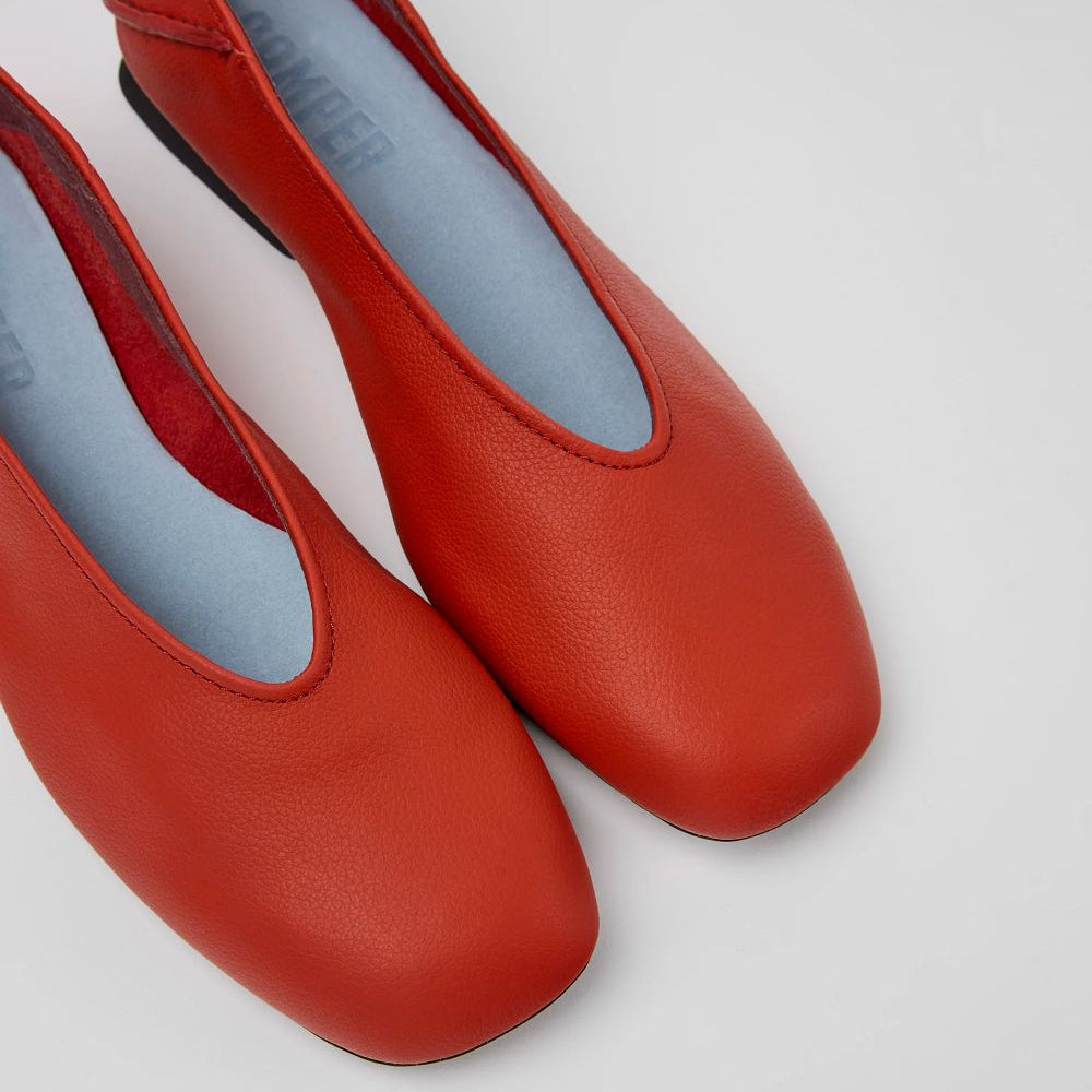 Pair of red shoes on a light gray background