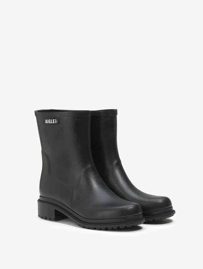 Black rain boots with Aigle logo on a white background