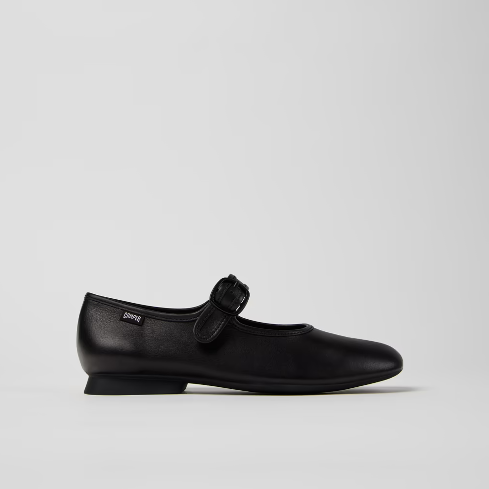 Black shoe with a bow on a light gray background
