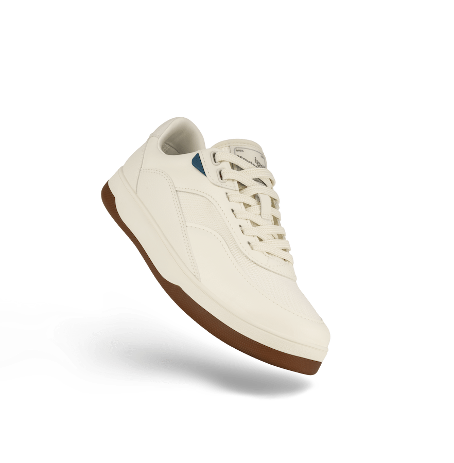 White sneaker with brown sole on a white background