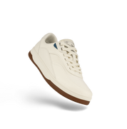 White sneaker with brown sole on a white background